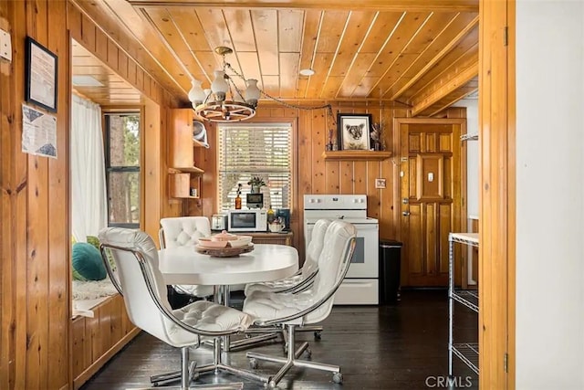 dining room with a chandelier, wood ceiling, dark hardwood / wood-style flooring, and wood walls