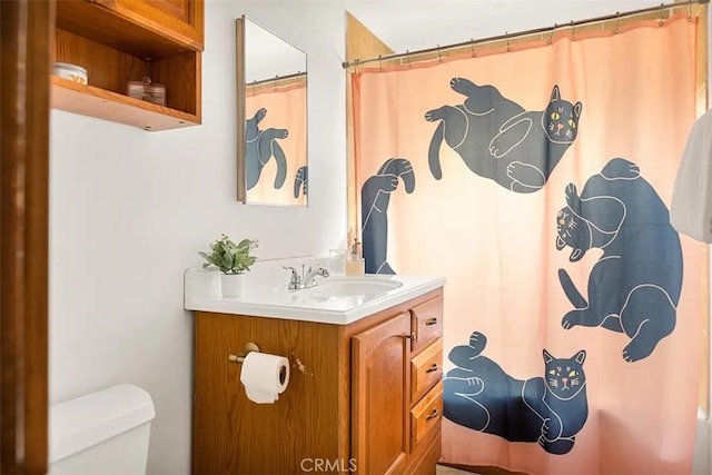 bathroom featuring toilet and vanity