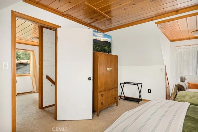 bedroom featuring wooden ceiling, light colored carpet, and vaulted ceiling