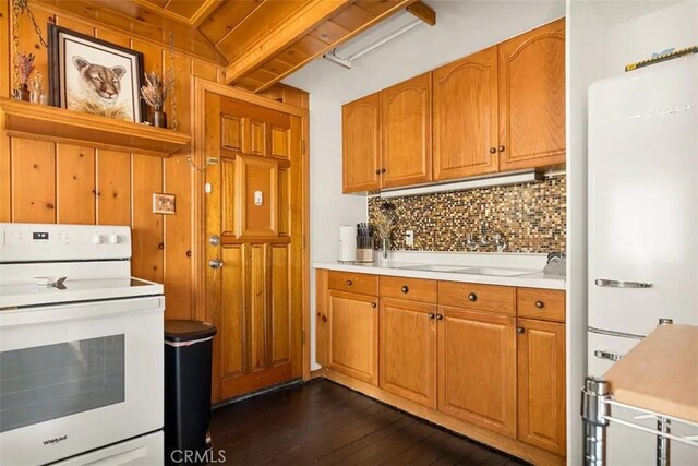 kitchen featuring dark hardwood / wood-style floors, backsplash, and white appliances