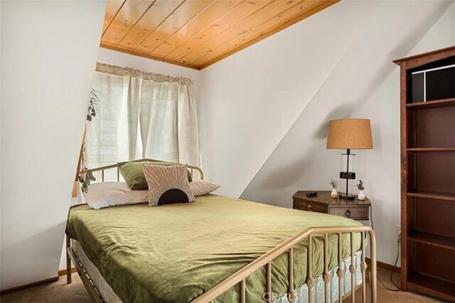 carpeted bedroom featuring crown molding and wood ceiling