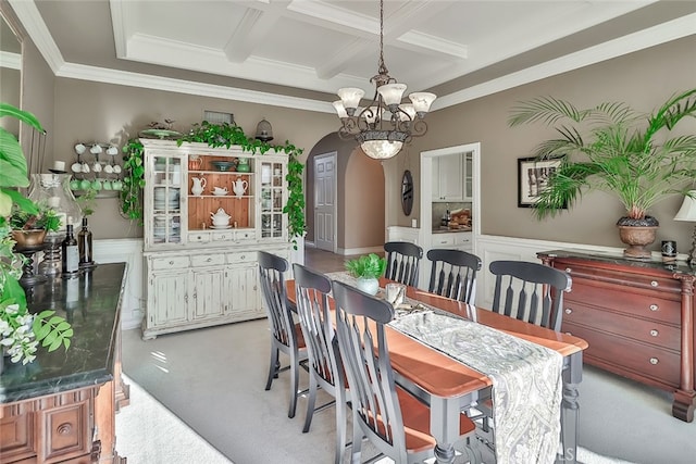 carpeted dining space featuring a notable chandelier, beam ceiling, coffered ceiling, and crown molding