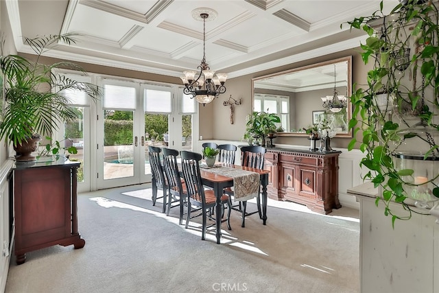 dining room with coffered ceiling, french doors, ornamental molding, light carpet, and a notable chandelier