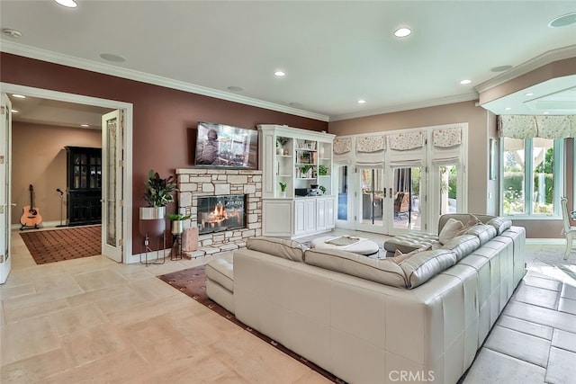 living room featuring a stone fireplace, ornamental molding, and french doors