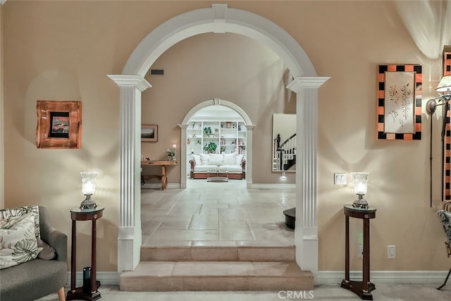 corridor featuring decorative columns