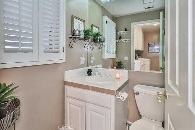 bathroom with vanity and toilet