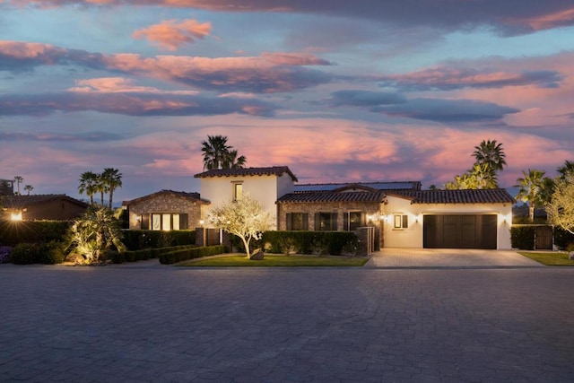 mediterranean / spanish-style house featuring a garage