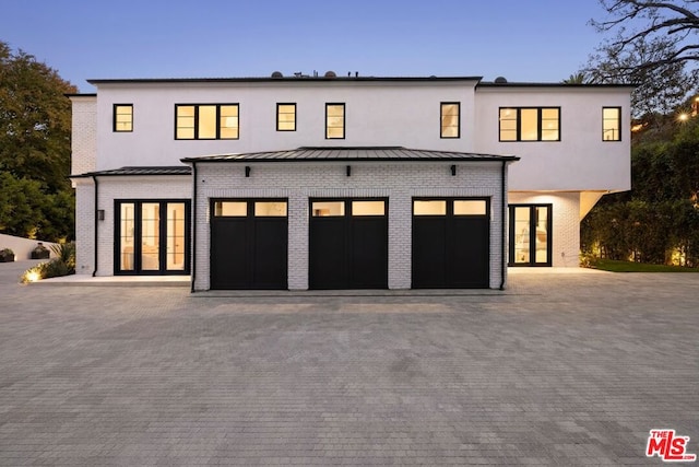 modern farmhouse featuring a garage and french doors