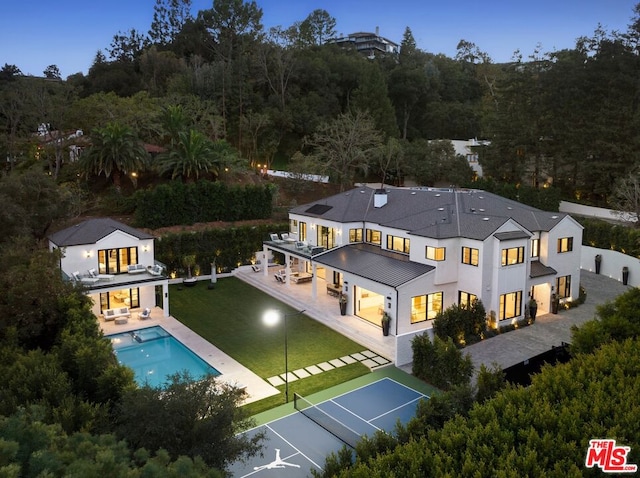 back of house with a balcony and a patio