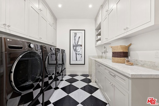 laundry area with washer and dryer and cabinets