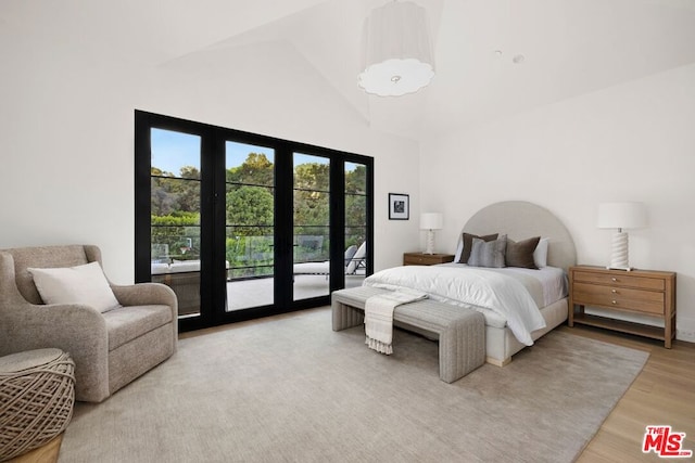 bedroom featuring access to outside, french doors, high vaulted ceiling, and wood-type flooring