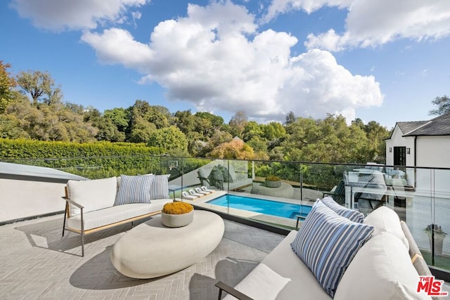 view of swimming pool with outdoor lounge area and a patio