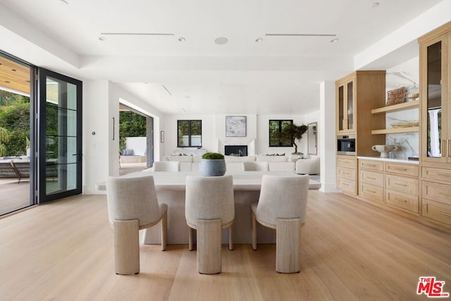 dining space with light wood-type flooring and a wealth of natural light