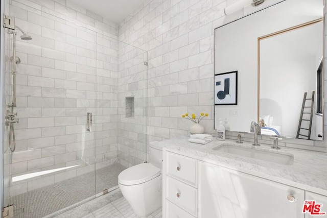 bathroom with tile patterned flooring, vanity, toilet, and an enclosed shower