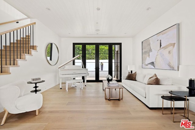 living room with french doors, wooden ceiling, and light wood-type flooring