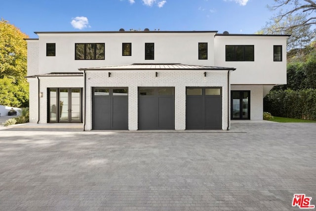 view of front of home with french doors and a garage