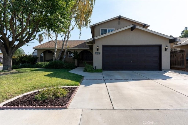 view of front of house with a garage and a front lawn