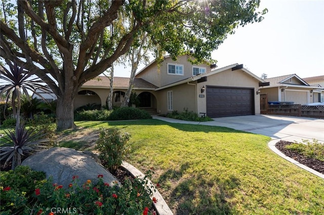 view of front of property featuring a front yard and a garage