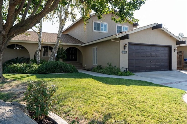 view of front of home with a front yard and a garage