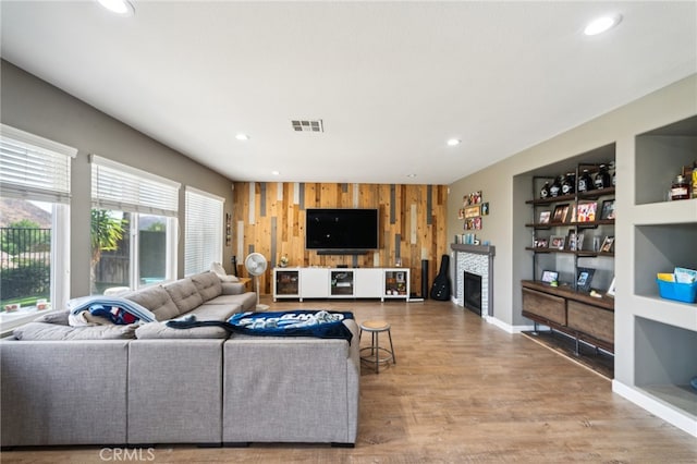 living room featuring wood-type flooring and wood walls