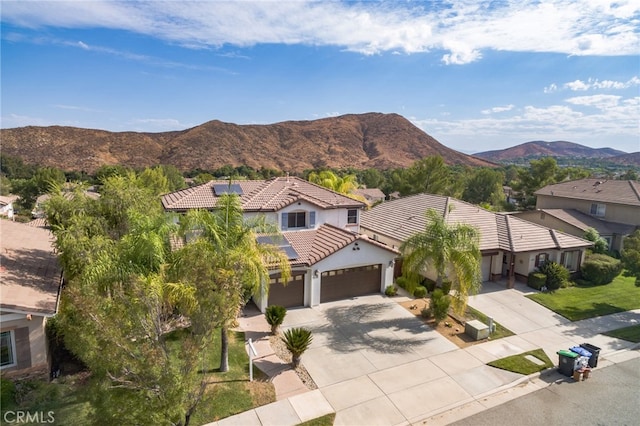 view of front of house with a garage and a mountain view