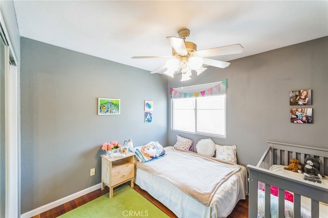 bedroom featuring wood-type flooring, ceiling fan, and a closet