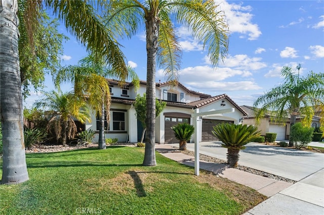 mediterranean / spanish-style house featuring a garage and a front yard