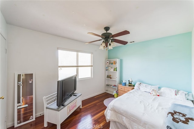 bedroom with ceiling fan and dark wood-type flooring