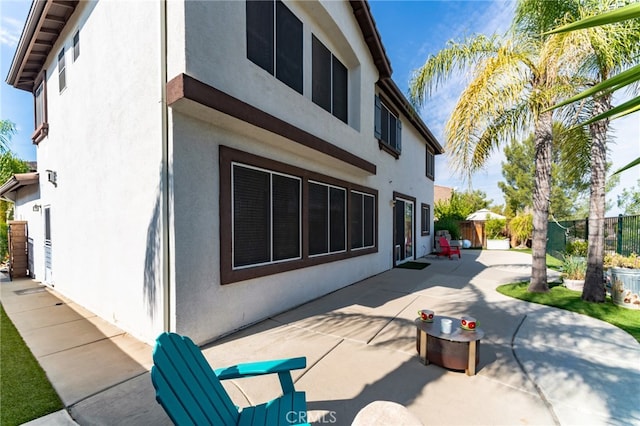 view of property exterior with a patio area