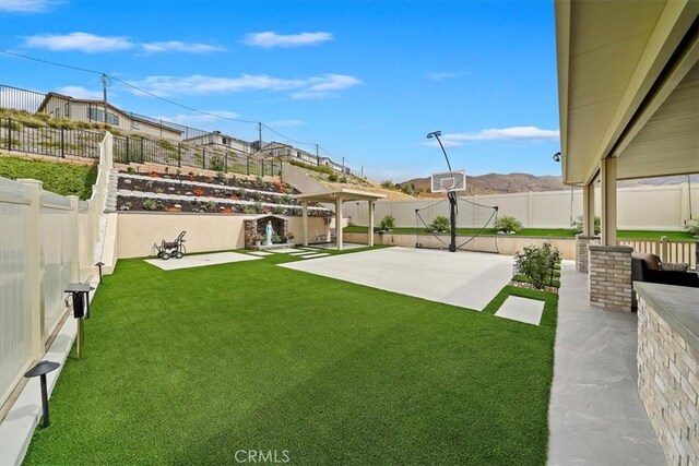 view of yard featuring a mountain view and a patio