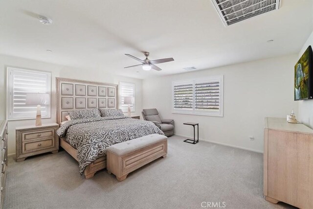 bedroom with ceiling fan and light carpet