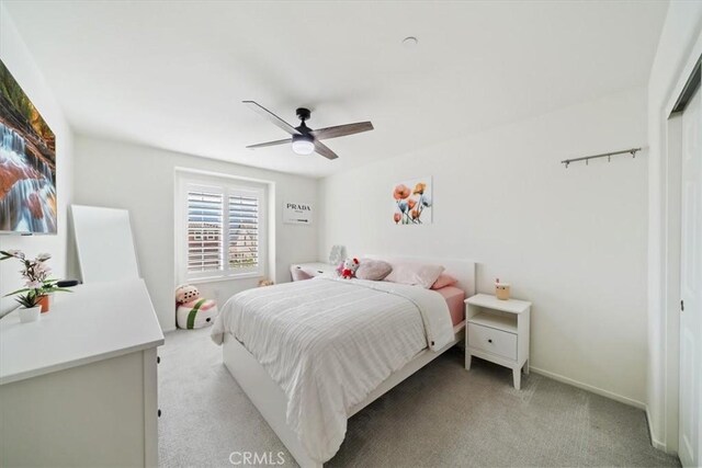 bedroom with ceiling fan and light colored carpet