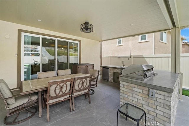 view of patio featuring a grill, area for grilling, and sink