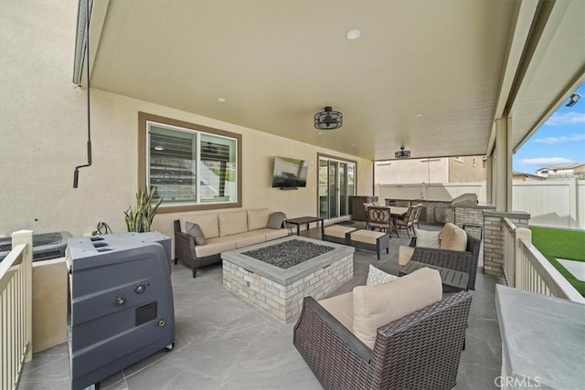 view of patio / terrace with an outdoor living space with a fire pit