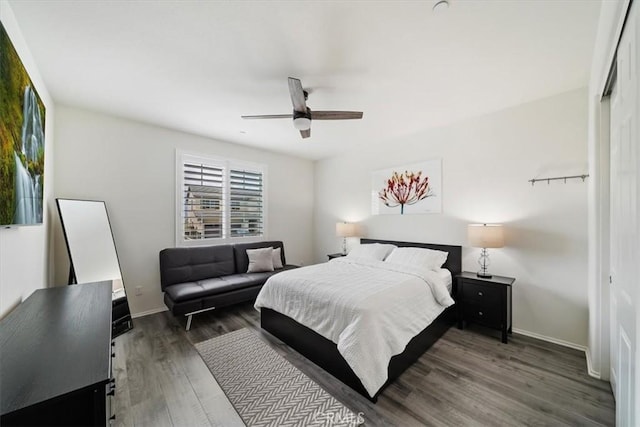 bedroom featuring ceiling fan and dark wood-type flooring