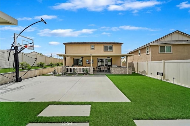 back of property featuring a lawn, a fenced backyard, and stucco siding