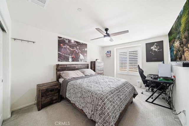 bedroom with ceiling fan and light carpet