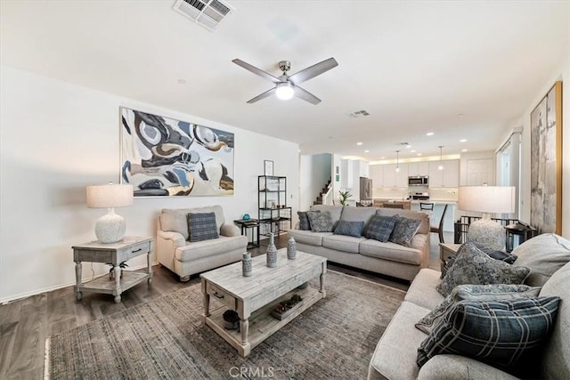 living room with dark hardwood / wood-style floors and ceiling fan