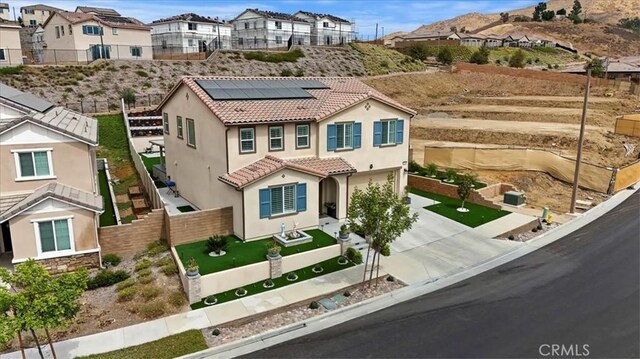 mediterranean / spanish house featuring solar panels