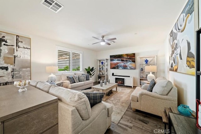 living room with hardwood / wood-style flooring and ceiling fan