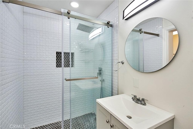 bathroom featuring vanity and an enclosed shower