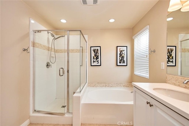 bathroom with vanity and independent shower and bath