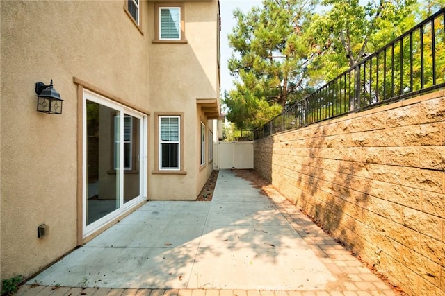 view of side of property with a patio area