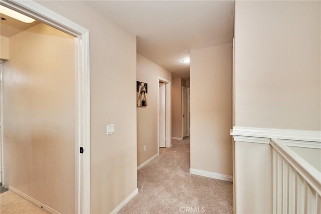 hallway featuring light carpet