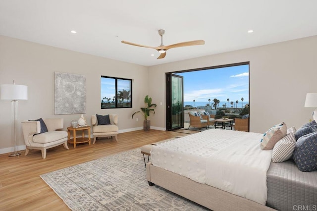 bedroom with wood-type flooring, access to outside, and ceiling fan