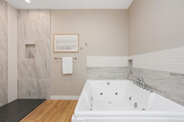 bathroom with hardwood / wood-style floors and a bathtub