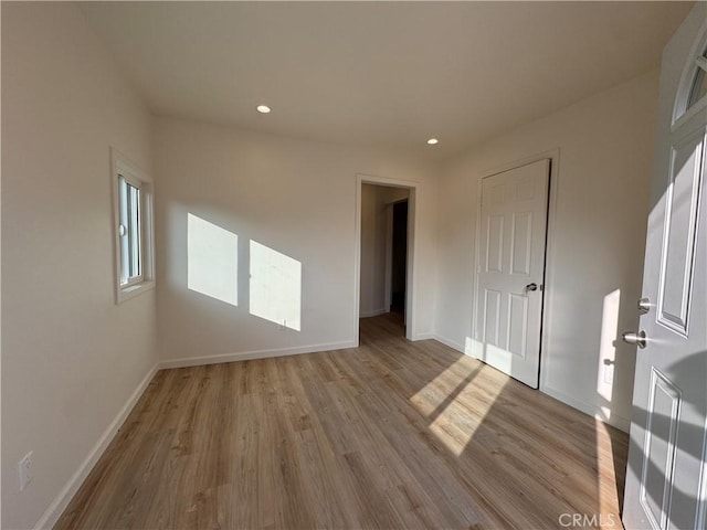 spare room with light wood-type flooring