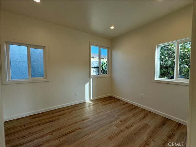 unfurnished room with light hardwood / wood-style flooring and plenty of natural light