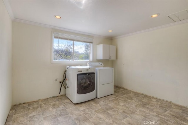 laundry area with ornamental molding, washing machine and dryer, cabinet space, and recessed lighting