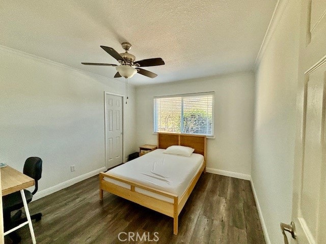 bedroom featuring ornamental molding, ceiling fan, dark hardwood / wood-style floors, and a textured ceiling